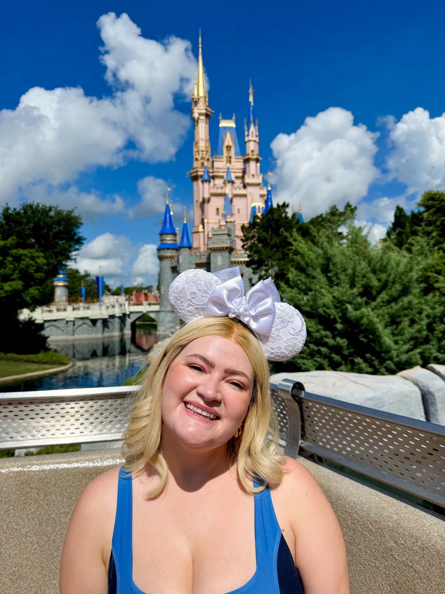 Person wearing bridal ears with castle in the background 