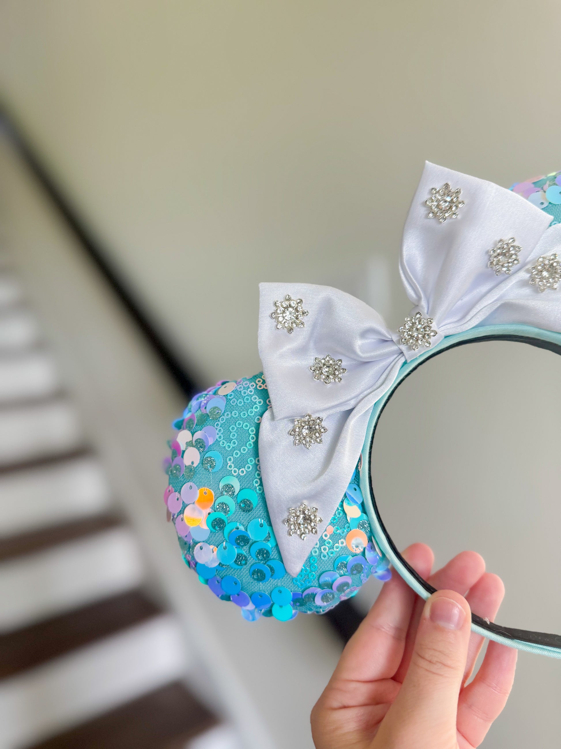 close up version of blue iridescent ears in front of stairs.