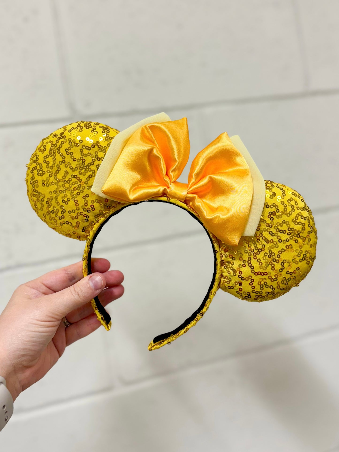 Yellow sequin mouse ears with a double satin yellow bow with the back bow being a light yellow. 