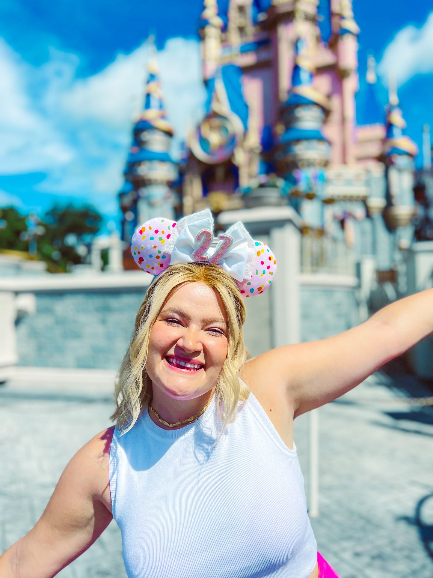 person wearing the ears from the previous photo in a theme park