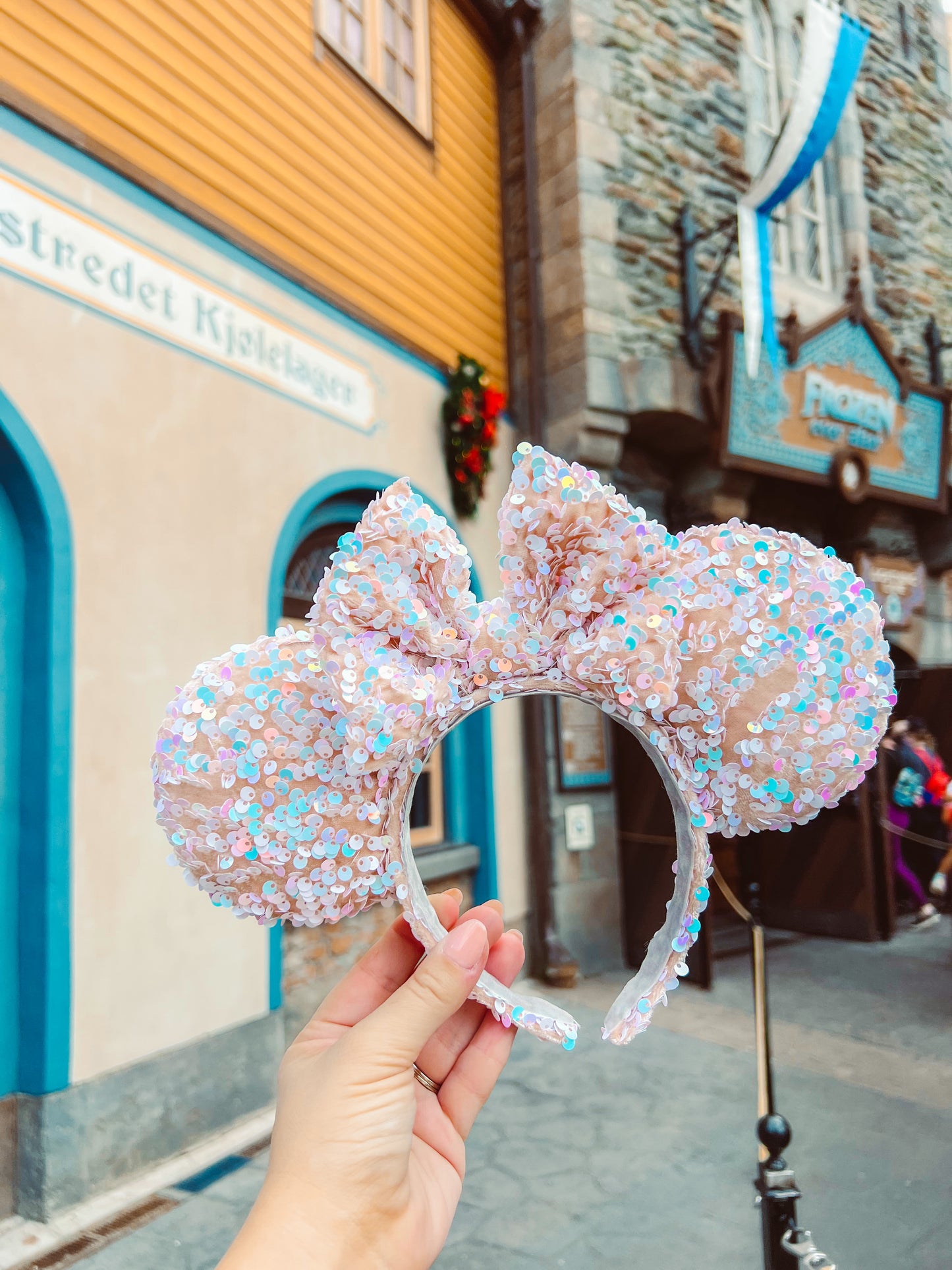 nude velvet mouse ears covered in iridescent blue and white sequins, the bow is in the same fabric
